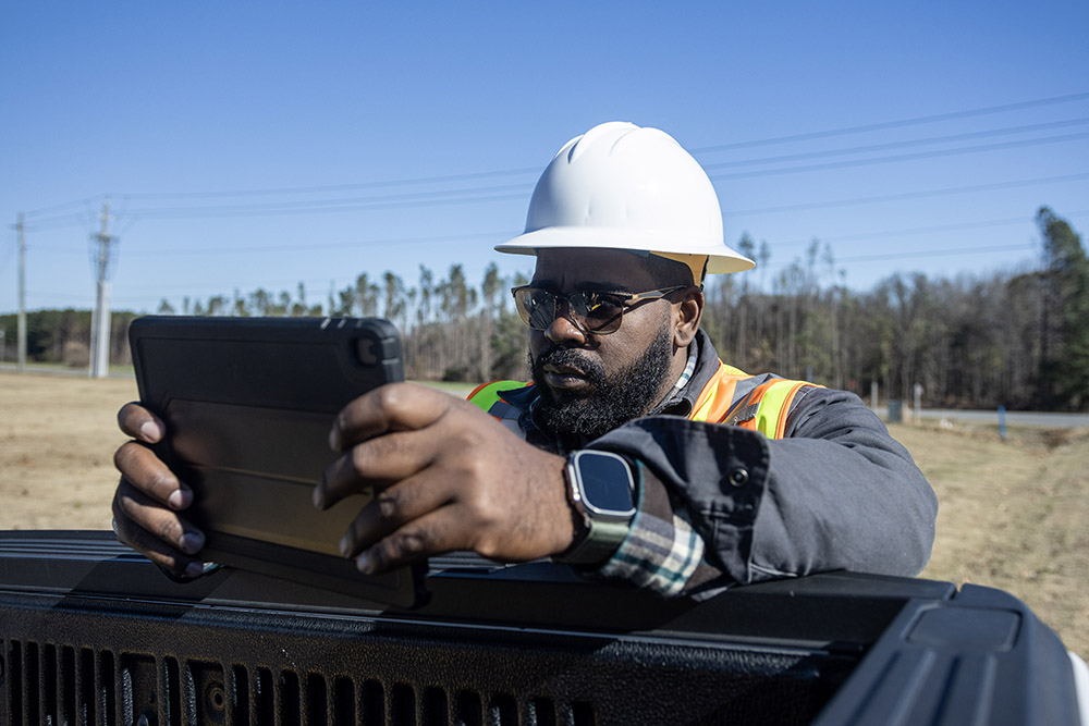 irby employee wearing heard hat looking at ipad